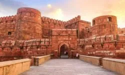 Agra Fort - Historic red sandstone fort of medieval India also known as the Red Fort Agra at sunrise. Agra Fort is a UNESCO World Heritage site in the city of Agra India.